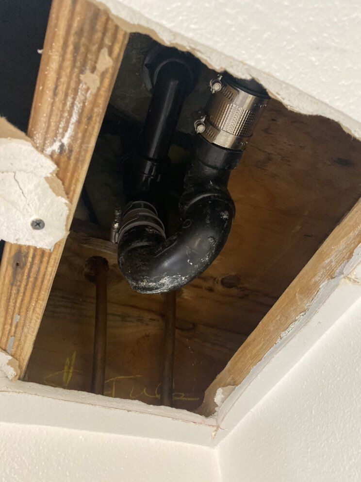 Drain line reached through a minimal ceiling access opening