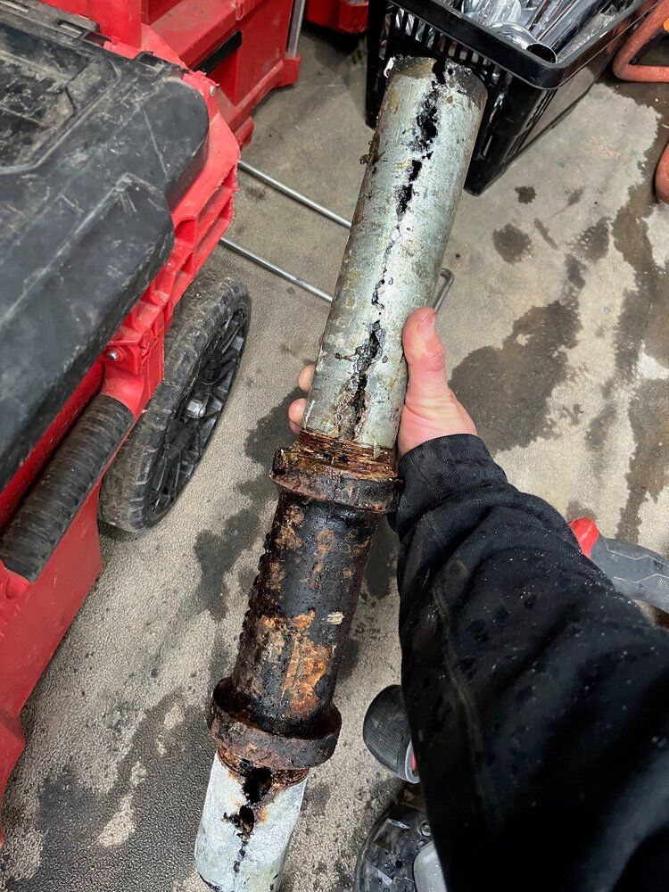 Removed pipe section — corrosion had opened the wall